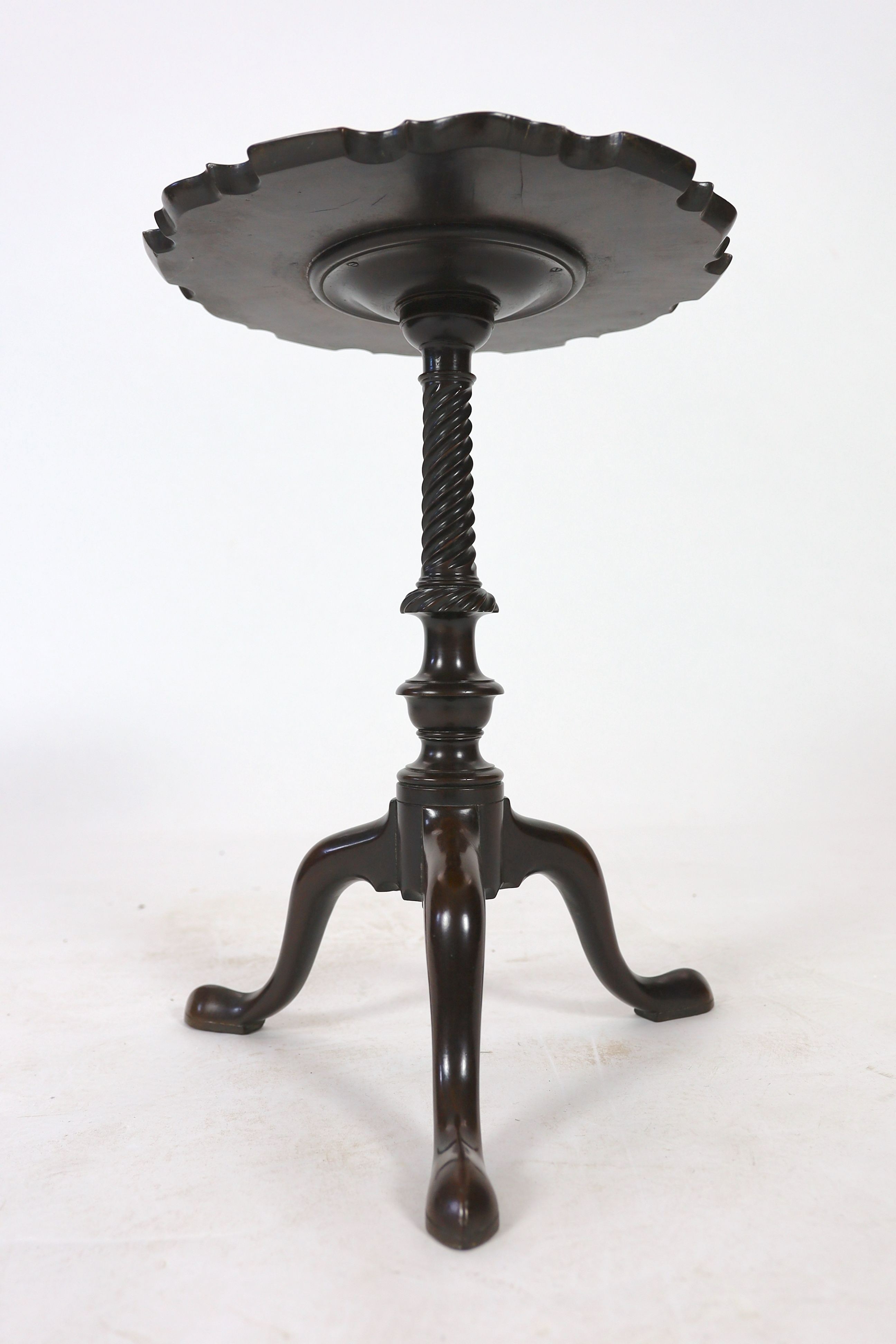 A George III and later mahogany tripod wine table, with circular piecrust top and spiral fluted stem on cabriole tripod base with pointed pad feet, diameter 38cm height 52cm